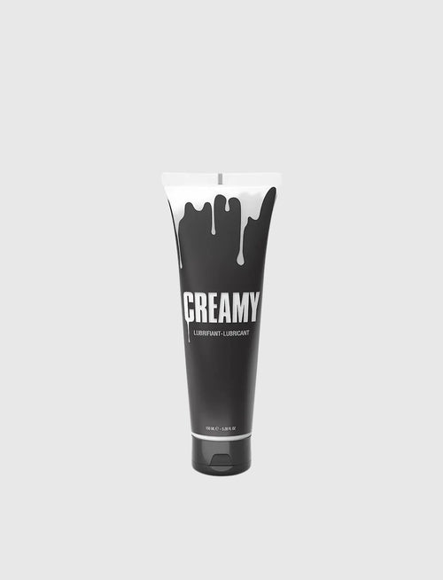 Black tube of fake-cum lubricant Creamy on a light gray background