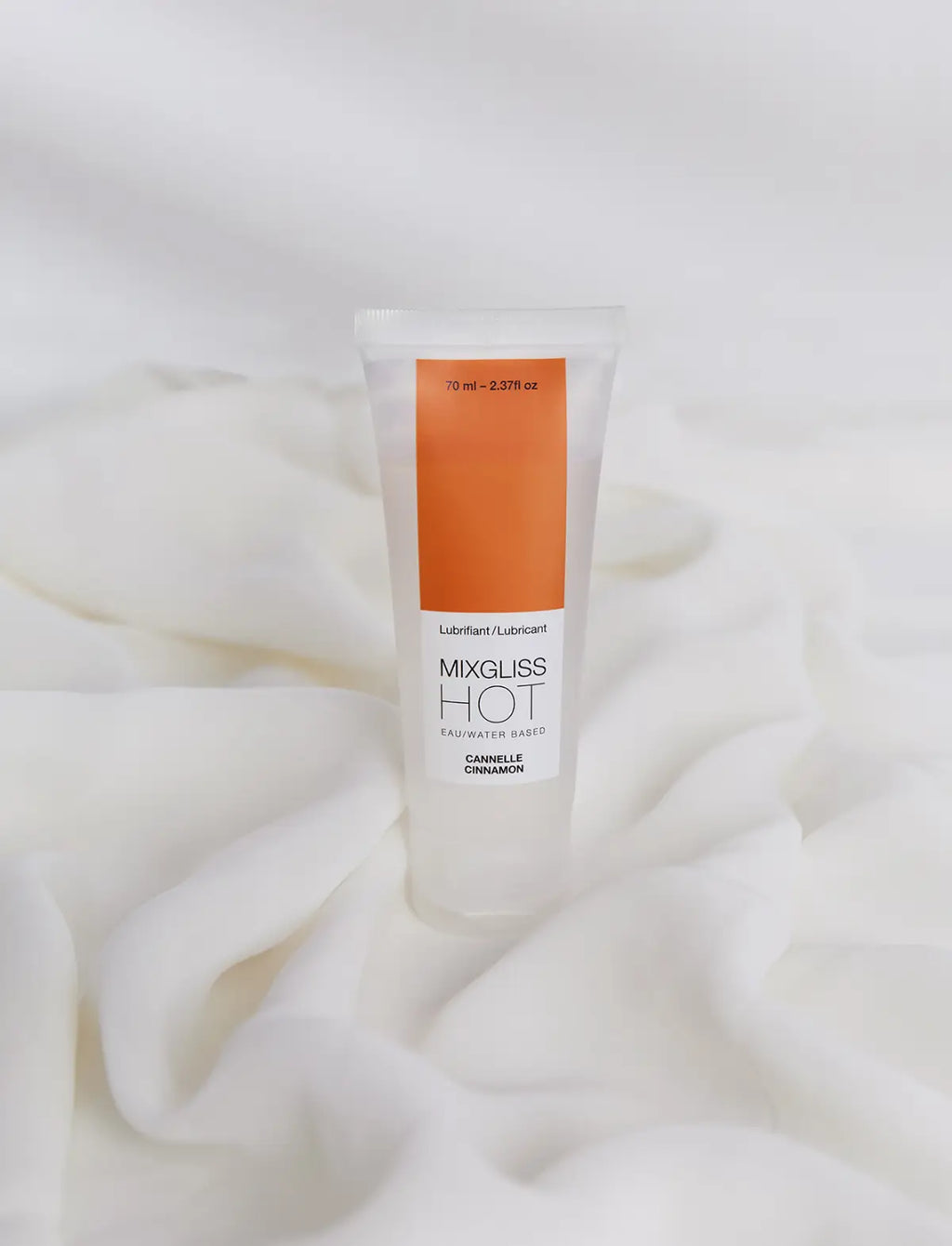 Tube of Mixgliss Hot lubricant on a white fabric background