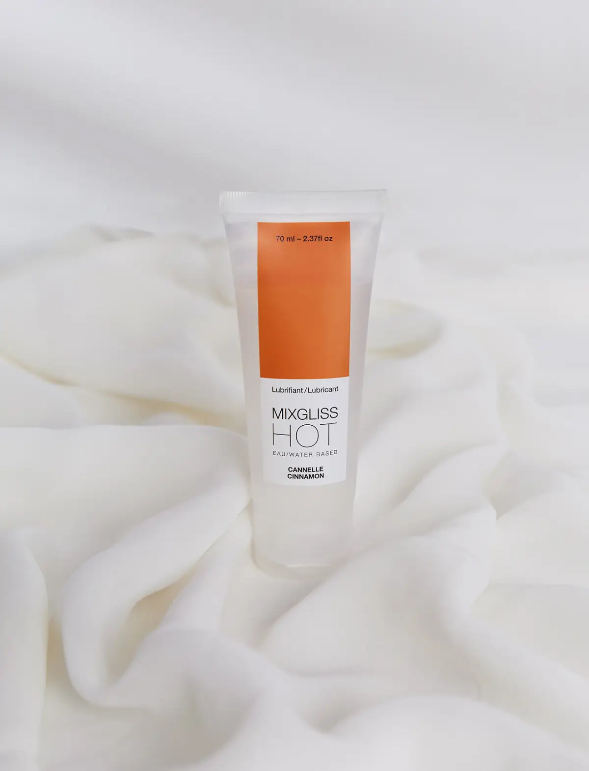 Tube of Mixgliss Hot lubricant on a white fabric background