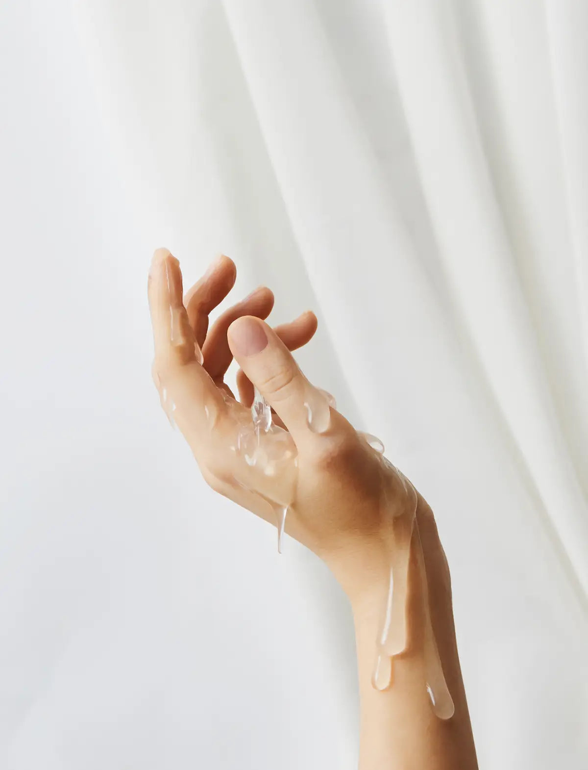 Hand showing the texture of the Mixgliss lubricant on a white background